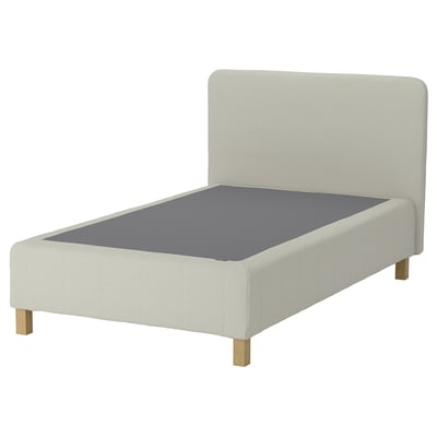 Minimalist bed, light fabric, grey mattress, wooden legs, sleek design.