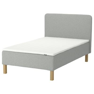 An IKEA RENFJÄLLET light grey upholstered bed in a minimalist style. The bed a soft headboard and wooden legs.