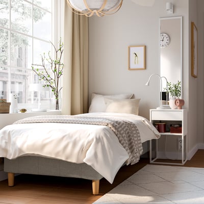 Cosy bedroom with RENFJÄLLET bed, large window, light woods, and soft lighting.