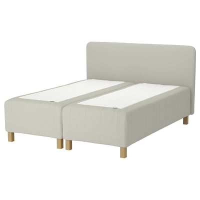 A modern white RISHÖJDEN bed with a padded headboard and rectangular wooden legs.