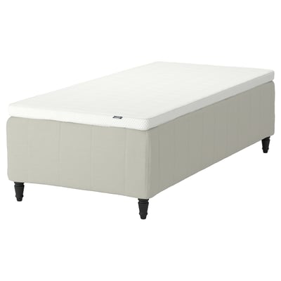 RISHÖJDEN bed: white, rectangular, upholstered base with dark legs, comfort-focused design.