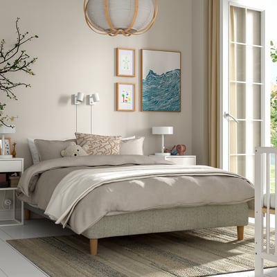 Modern bedroom with RISHÖJDEN grey bed, artwork, curtains, linens, nightstands, lamps, plant, hanging light.