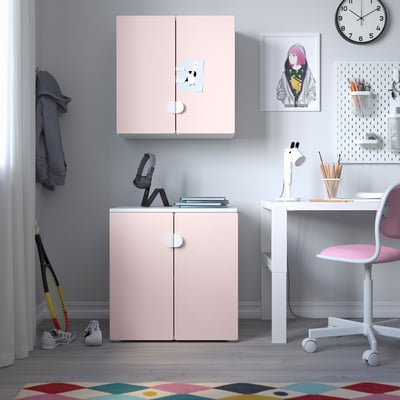 Childs organised study area with pink SMÅSTAD cabinets, white desk, posters.