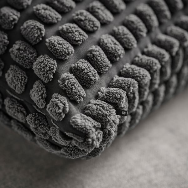 Soft, textured cushion cover with even stitching and plush details.