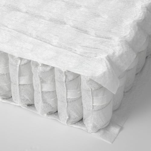 Close-up of a rolled mattress, showcasing its layered, cushioned design and quality craftsmanship.