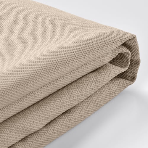 Folded beige sofa cover, textured with subtle two-tone effect.