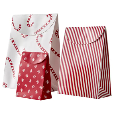 Two brown paper gift bags with white patterns: one with candy canes, the other with stripes.