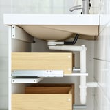 Wall-mounted bathroom cabinet with sink and wooden storage.