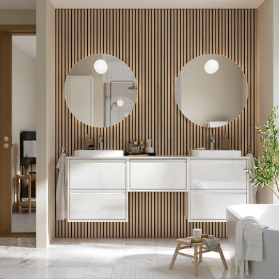 Modern white ÄNGSJÖN vanity with drawers, open compartment, and two square basins under round mirrors.