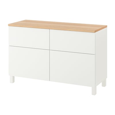 White BESTÅ storage unit with wooden top, four sections, two drawers, clean modern design.
