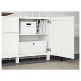 White sideboard with two open doors revealing storage boxes and books. Adjustable shelves and drawers with push-open function.