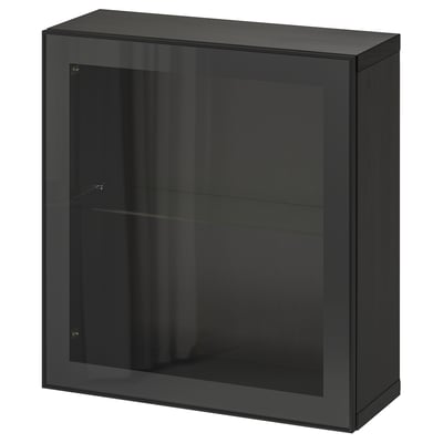 A black IKEA BESTÅ storage unit with a glass door and glossy finish. Its rectangular, featuring a glass shelf inside and a sleek, modern design.