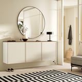 Modern entryway with BESTÅ sideboard, mirror, lamp, and vase on wooden top. Black & white rug, shoes beside, clean aesthetic.