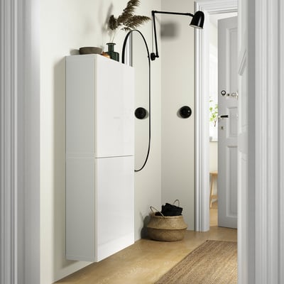 Modern BESTÅ cabinet with 2 doors, storage, lights, basket & decor.