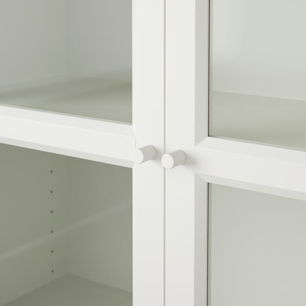 White BILLY bookcase with clear glass doors and strong hinges.