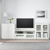 BRIMNES tv stand with flat screen, open shelves, & side cabinets for storage.