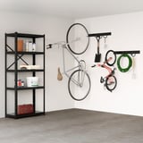 Organised garage with BROR black metal shelves holding tools & bikes. Bikes hang vertically, saving space.