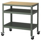A BROR multi-use trolley in green with a wooden top. It has three shelves with casters for mobility.