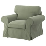 Sage green EKTORP armchair, soft fabric, rolled arms, clean lines.