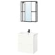 Modern bathroom setup with white cabinet, black fixtures, and framed mirror.