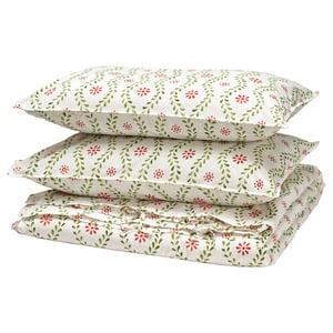 A stack of FYRISVIDE duvet covers featuring a floral print in white, green, and red, made of 100% cotton.