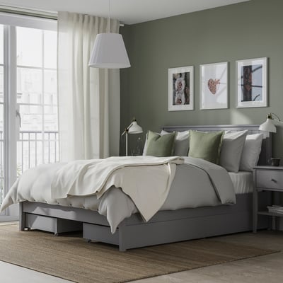 Modern bedroom with GULLABERG bed, green pillows, white curtains, and wall art.