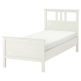 A HEMNES white wooden twin bed with a high headboard and footboard. Its made of sustainably sourced solid pine, providing a clean and simple design.