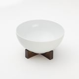 IKEA 365+ white bowl on dark acacia stand, minimalist design enhances dining.