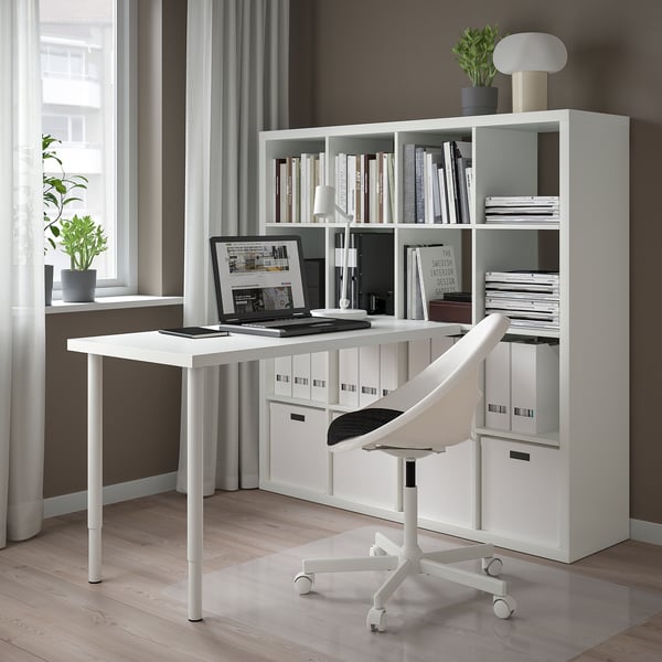 Minimalist home office with KALLAX shelf, laptop desk, and sleek chair.