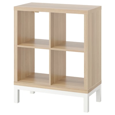 KALLAX light brown wooden shelving unit with white legs, square compartments, modern minimalist design.