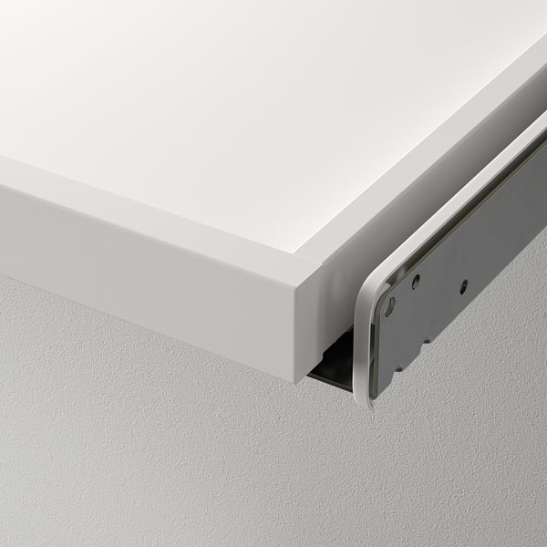 White wall-mounted cabinet with a sleek pull-out drawer, featuring a metal slide mechanism, attached to a smooth white wall.