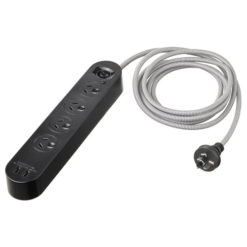 A black KOPPLA multi-socket with 4 outlets and 2 usb ports, made of polycarbonate plastic. It has a braided cord and a compact design.