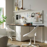 Cosy home office with LAGKAPTEN desk, storage, ergonomic chairs, and pegboard.