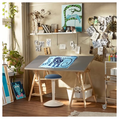 Bright studio with LAGKAPTEN desk, wooden legs, blue art, plants & decor.