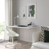 Minimalist home office: white LAGKAPTEN desk, sleek chair, modern decor.