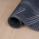Black floor protector with white patterns guards floors from gaming chair marks, non-slip for smooth, quiet movement.