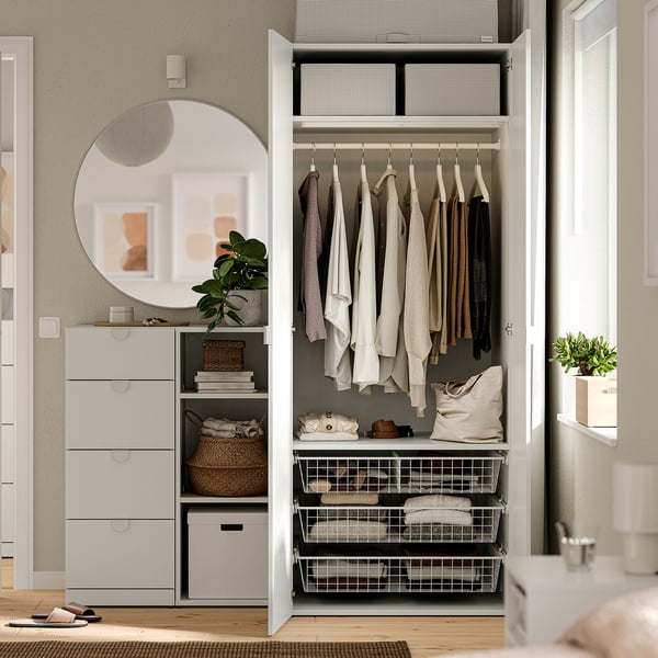 Open wardrobe with clothes, storage baskets, and drawers. Adjustable feet for uneven floors.