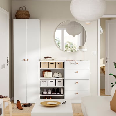 Minimalist entryway with LASTARE storage, mirror, lights, and tidy items.