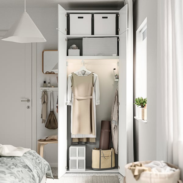 Open wardrobe with dress, boxes, hangers; adjustable feet for floor levelling.