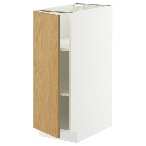 A white METOD kitchen cabinet with a light oak veneer door, featuring adjustable shelves and metallic hinges.