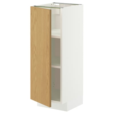 A white METOD cabinet with a light wooden door partially open, revealing two shelves inside.