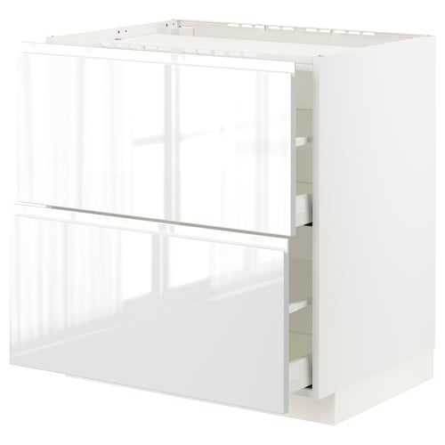 A white high gloss METOD kitchen cabinet with integrated handles and smooth-running drawers.
