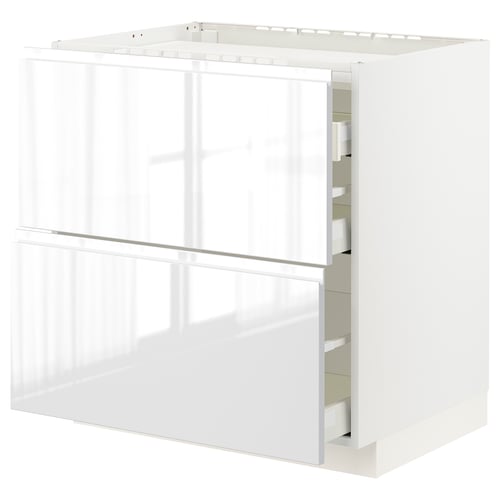 White modern kitchen unit with glossy surfaces and integrated handles, METOD drawer system.
