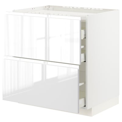 White modern kitchen cabinet with sleek, glossy finish and integrated handles, featuring multiple drawers for storage.