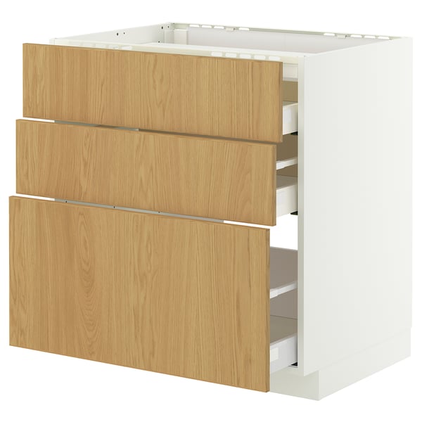 A modern white and light wood kitchen cabinet with three drawers. The unit includes multiple compartments for storage.