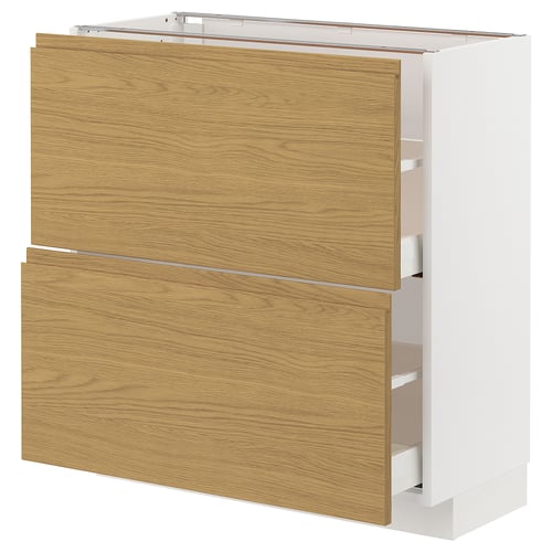 METOD kitchen unit with oak-effect drawers and integrated handles. White with wooden grain texture, rectangular shape.