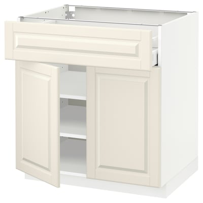 Off-white kitchen cabinet with bevelled edges, two doors, and an open shelf. Modern, minimalist design.