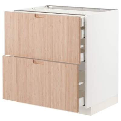 White METOD kitchen cabinet with bamboo doors open, showing storage spaces.