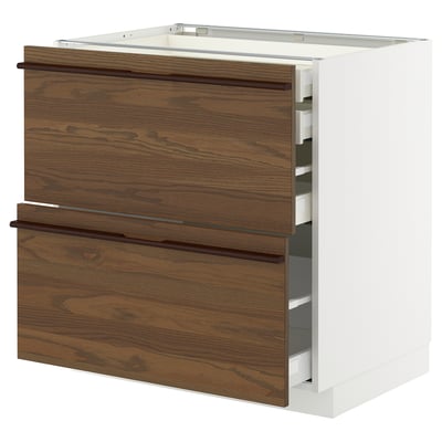 METOD kitchen cabinet with dark brown wood drawers and white base.