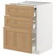 Modern kitchen unit METOD with white frame and oak drawers, featuring multiple drawers.